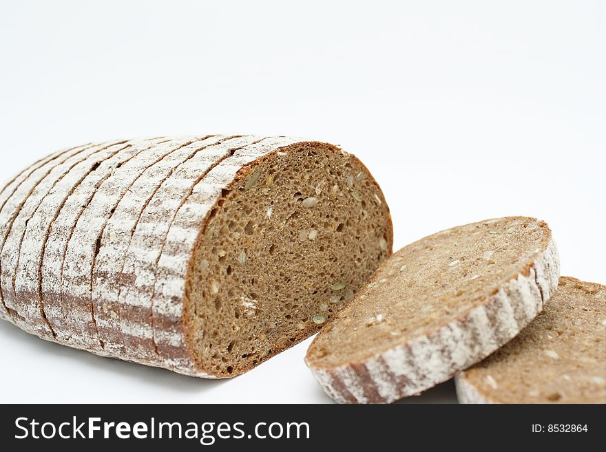 Sliced loaf of cereal bread on white background