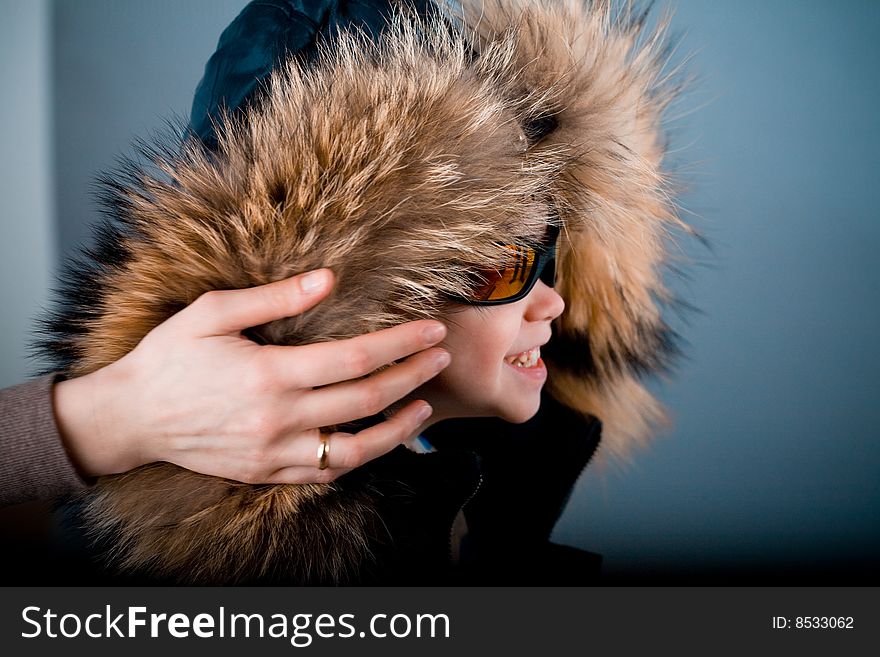 Child in jacket with fur hood. Child in jacket with fur hood