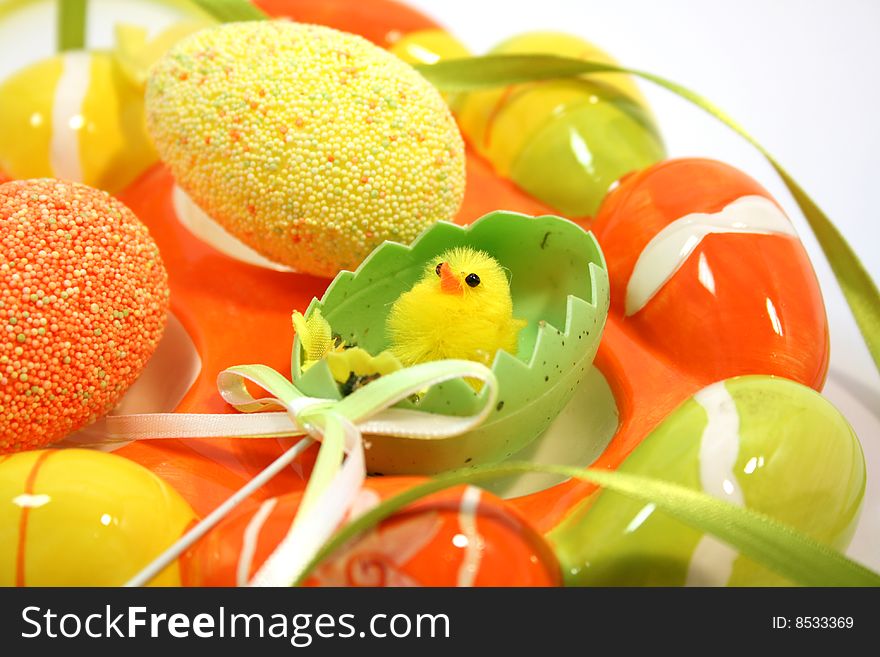 Egg shaped dish holding colorful Easter eggs