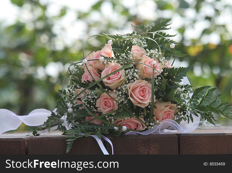 wedding bouquets with pink roses on the outside of trees with background