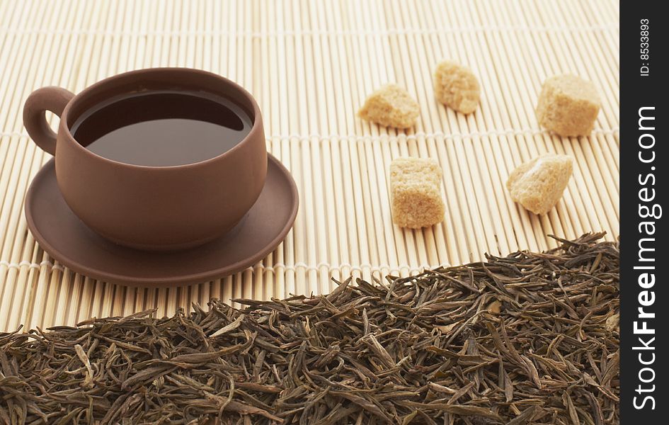 Clay cup of tea and sugar in the bamboo background