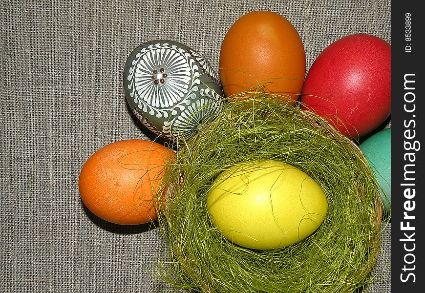 Different colour Easter eggs on linen background