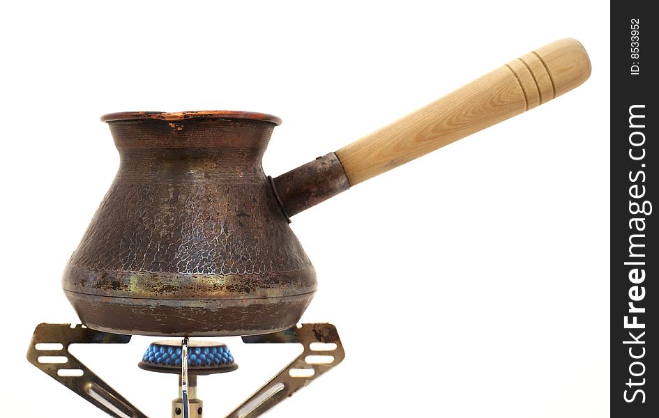 Coffe pot on a gas burner is isolated on a white background