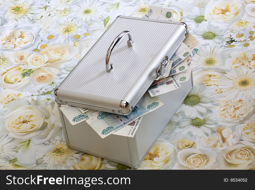 Case, full of money on decorative background