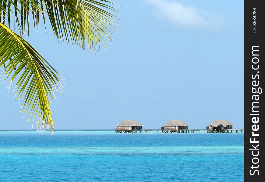 Foreshortening with overwater bungalows in a beautiful sunny day at the maldives. Foreshortening with overwater bungalows in a beautiful sunny day at the maldives