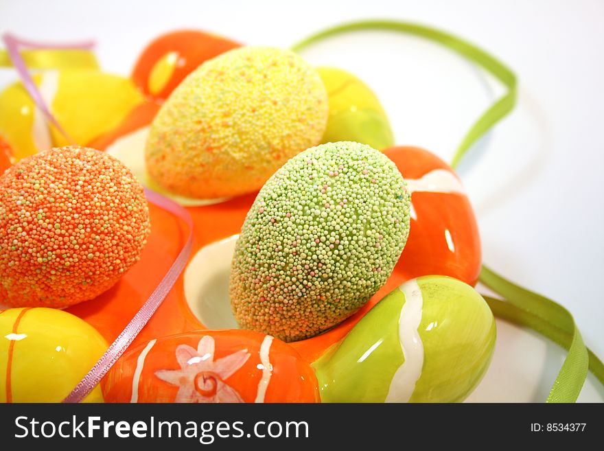 Egg shaped dish holding colorful Easter eggs