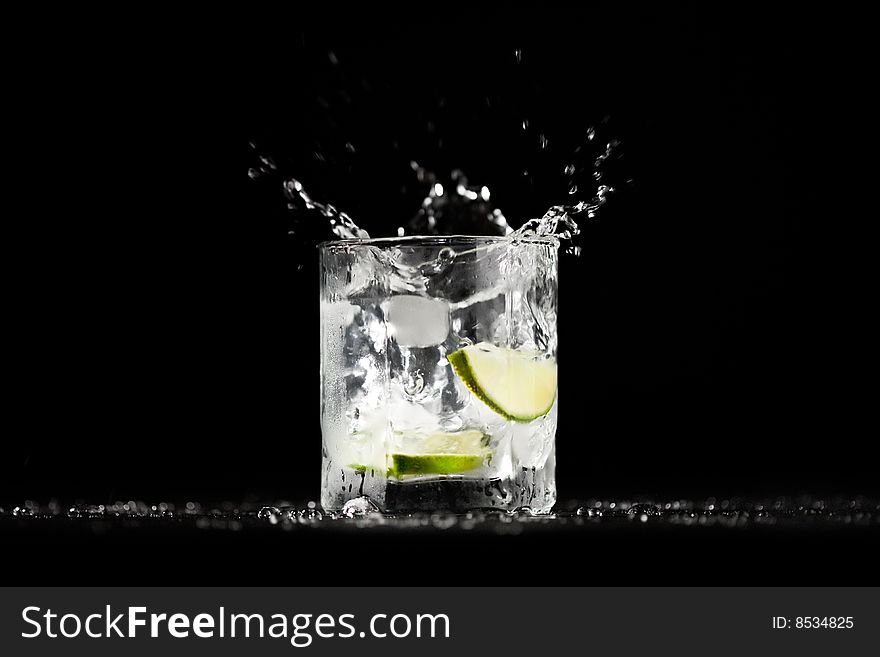 Ice water exploding in a tumbler with lime. Image series. Ice water exploding in a tumbler with lime. Image series.