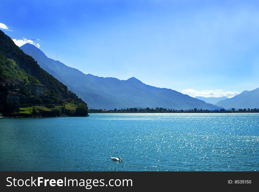 Swan lake with mountains and blue sky