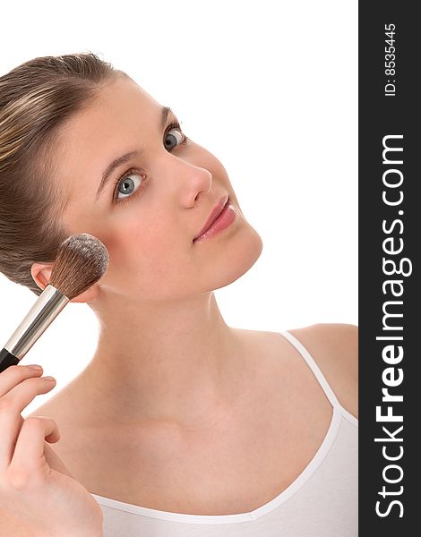 Body care - Young woman doing make-up on white background
