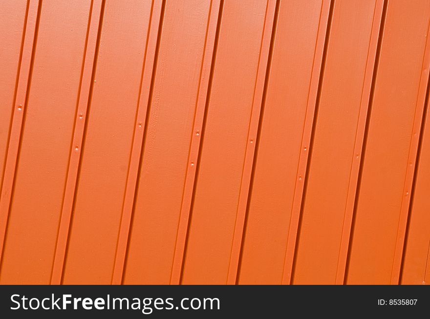 Corrugated metal panel painted in vivid orange. Corrugated metal panel painted in vivid orange.