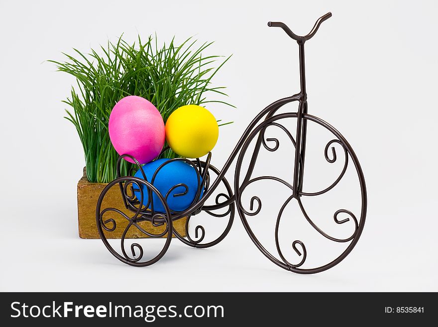 Dyed Easter eggs on vintage bike. Isolated studio shot.