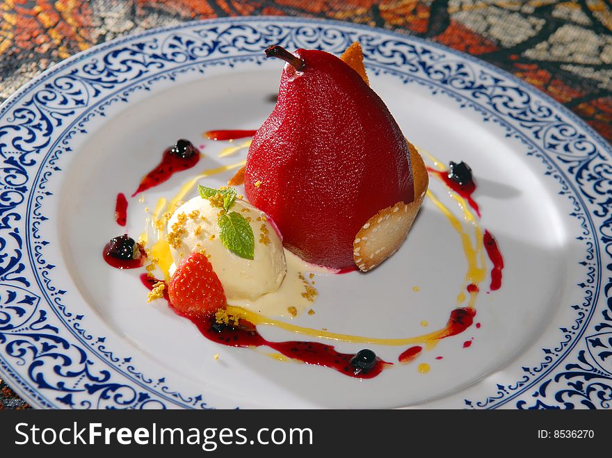 Marinaded pear with ice-cream and berries