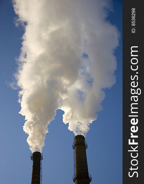 Smoke from a pipe on a background of the light-blue sky. Smoke from a pipe on a background of the light-blue sky.