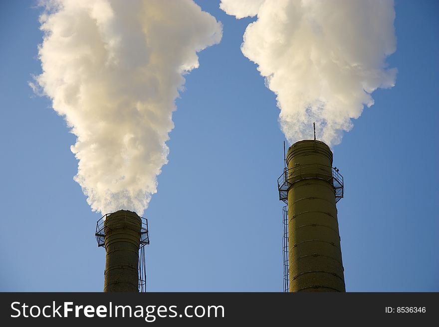 Industrial pipe on a background of the light-blue sky. Industrial pipe on a background of the light-blue sky.