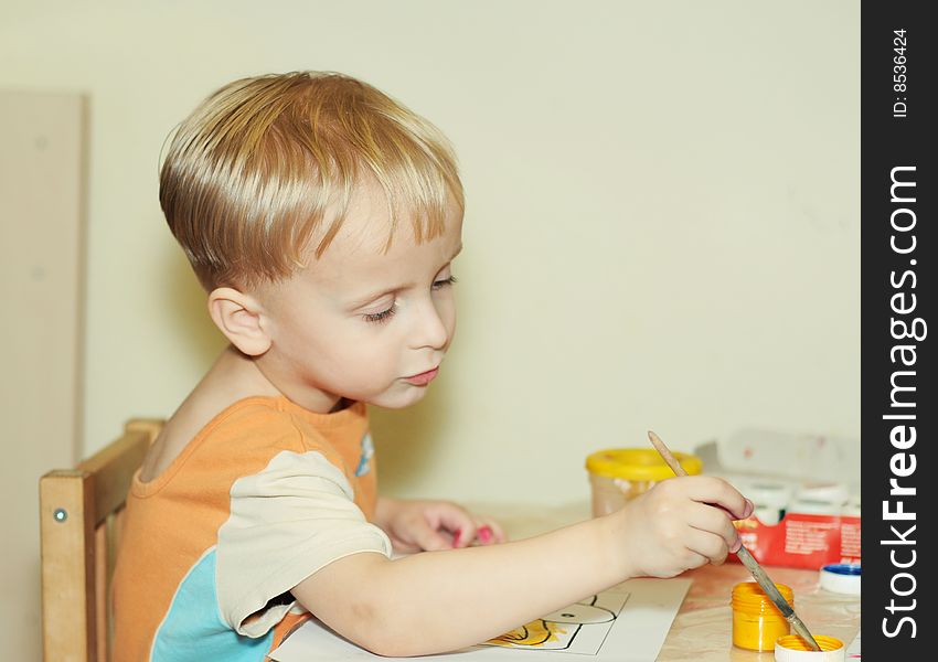 Toddler boy paints by gouache. Toddler boy paints by gouache