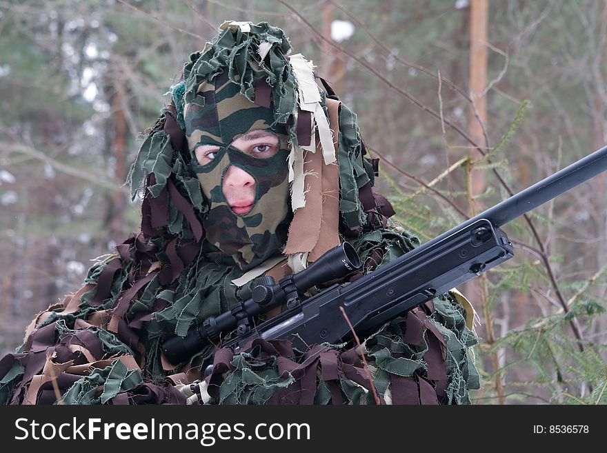 Man in a camouflage with a sniper gun