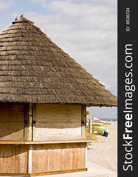 A bamboo and straw hut on an empty beach. A bamboo and straw hut on an empty beach