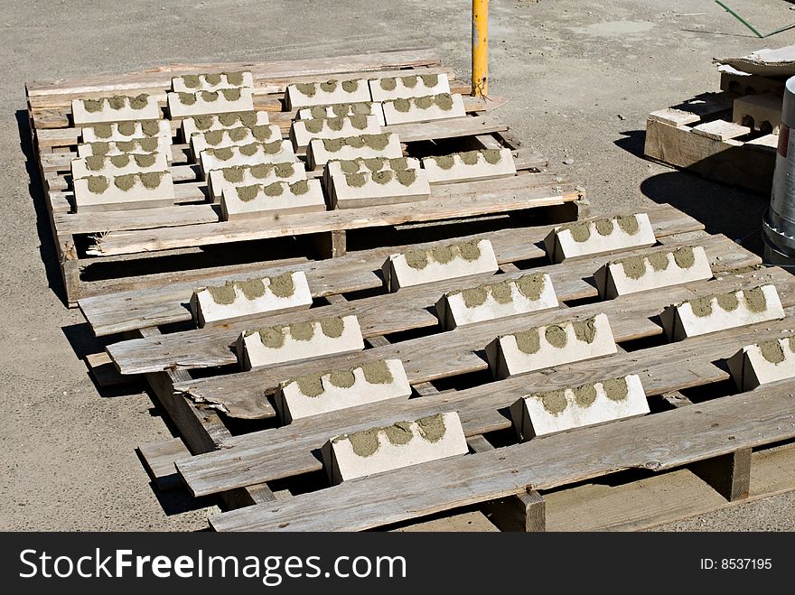 Bricks mortared together to form corners drying in the sun. Bricks mortared together to form corners drying in the sun.