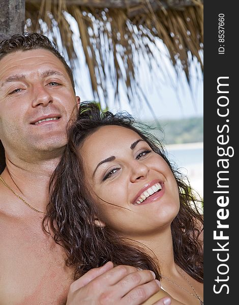 A portrait of attractive couple having fun on the beach. A portrait of attractive couple having fun on the beach.