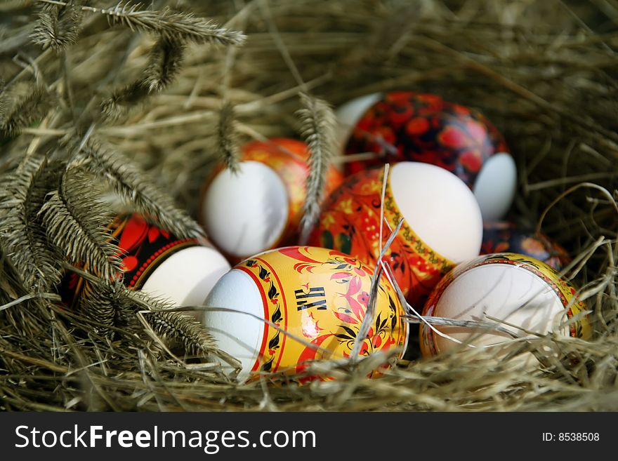 Many Easter eggs lie in a nest. Many Easter eggs lie in a nest