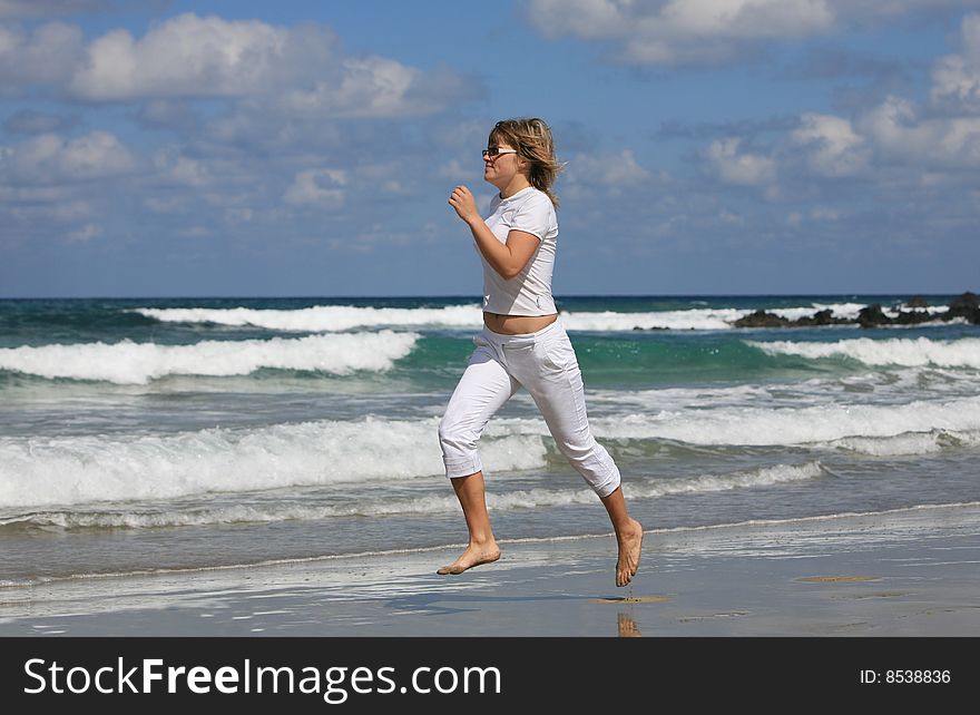 Running woman on the beach