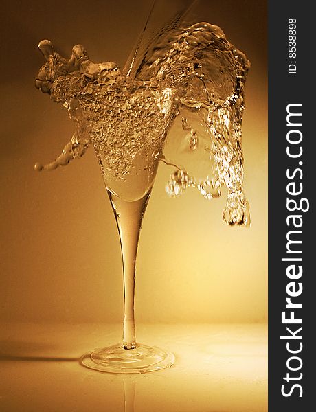 Pouring a glass of wine (or water, or champagne, or whatever you prefer) with a nice splash for dramatic effect.