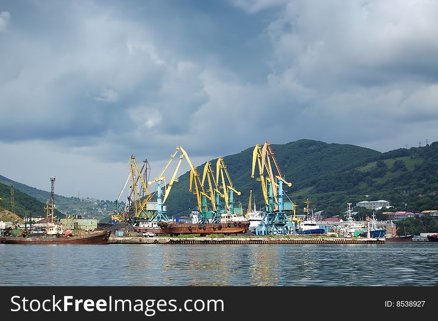 A small port with cranes and ships. A small port with cranes and ships