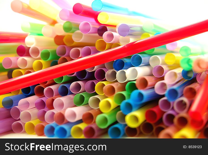 Many color cocktail straws isolated on white