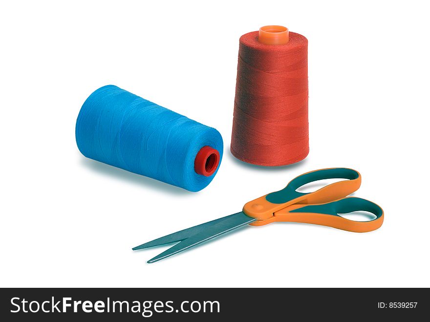 Spools and scissors against white background