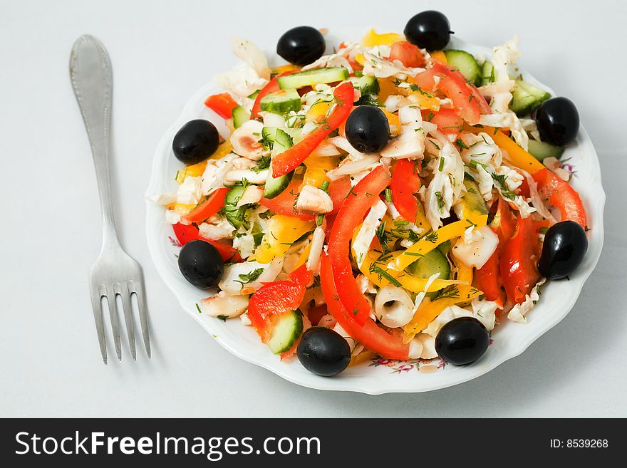 Stock photo: an image of fork and a plate of salad. Stock photo: an image of fork and a plate of salad