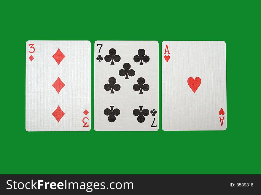 Playing cards isolated against green background