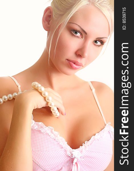 Portrait of the beautiful blonde with a pearl beads in a hand. Portrait of the beautiful blonde with a pearl beads in a hand