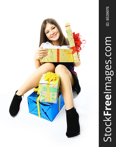 Happy young beautiful woman on the floor with a lot of presents. Happy young beautiful woman on the floor with a lot of presents