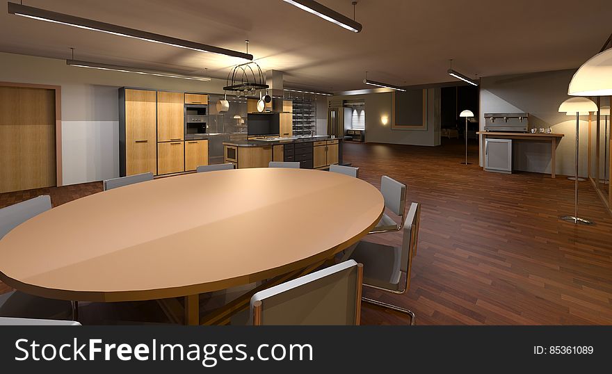 A modern dining room with a round wooden table.