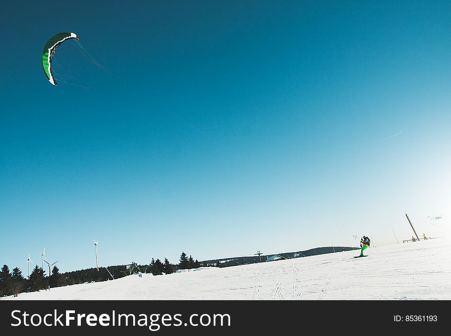 Man Skiing on Snow Covered Landscape