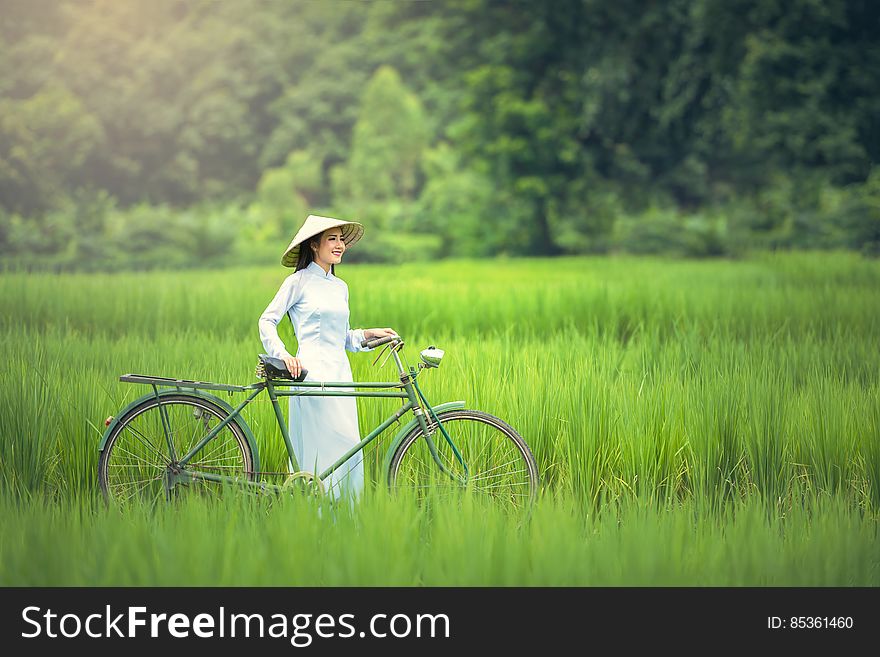 Woman With Bicycle on Grass