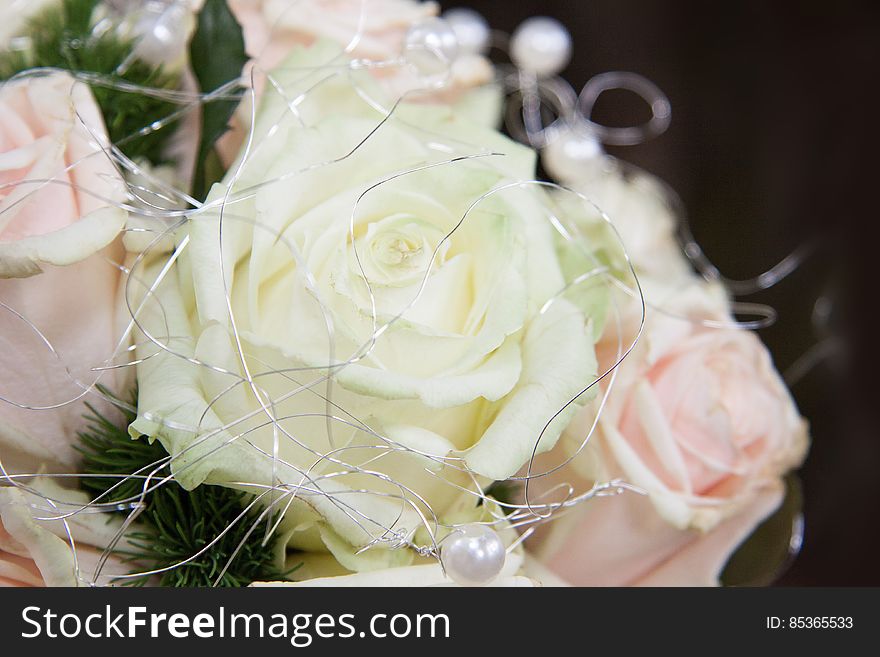 Close up of bridal bouquet with pink and white roses covered in silver threads. Close up of bridal bouquet with pink and white roses covered in silver threads.