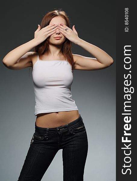 The woman in jeans on a dark background. The woman in jeans on a dark background