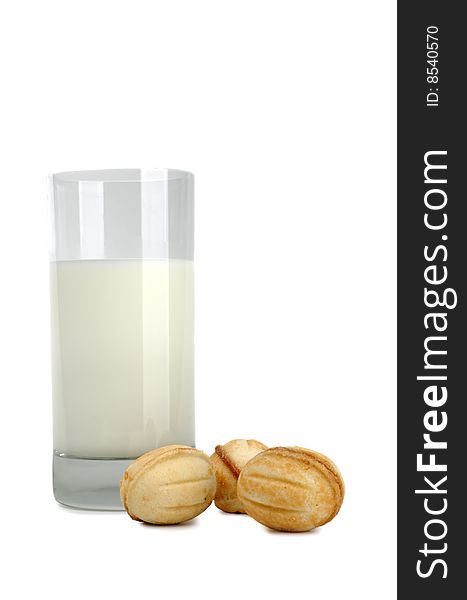 Glass of fresh milk and cookies on a white background