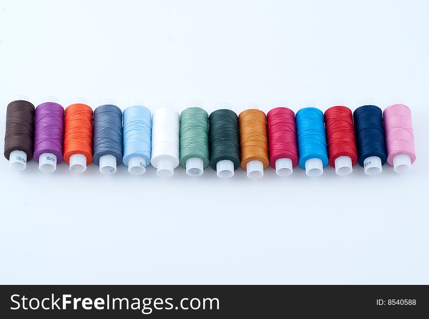 Row of colorful sewing spools