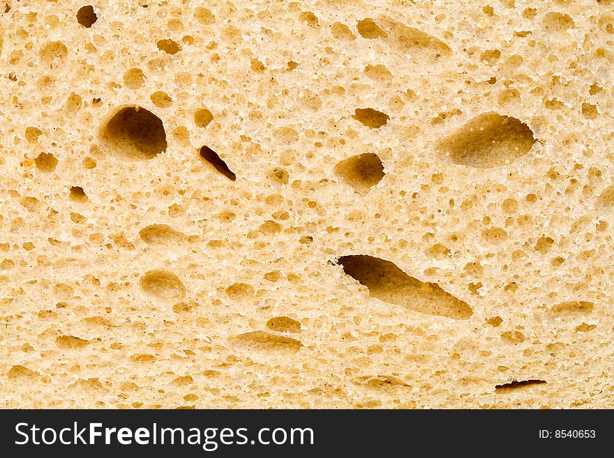 A close up of the texture of a slice of white bread. A close up of the texture of a slice of white bread