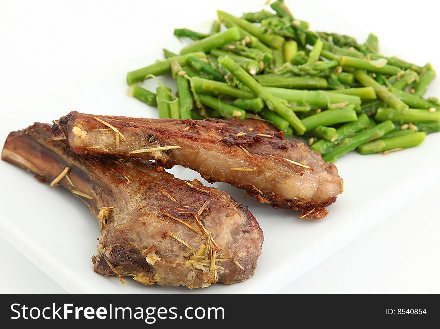 Grilled Ginger Lamb Chops and Steamed Asparagus over white.