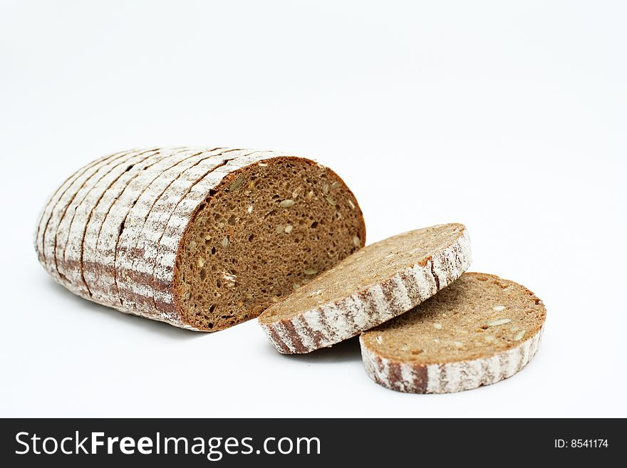 Sliced loaf of cereal bread on white background