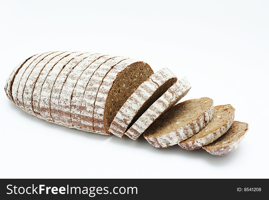 Sliced loaf of cereal bread on white background