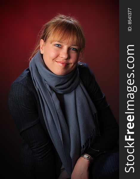 Portrait of female on a red background in studio