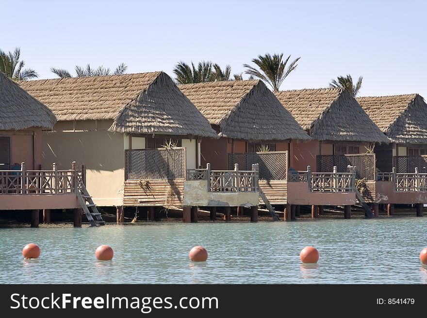 Primitive style water front cabins overlooking a lagoon in the red sea city of El Gouna, Egypt. Primitive style water front cabins overlooking a lagoon in the red sea city of El Gouna, Egypt.