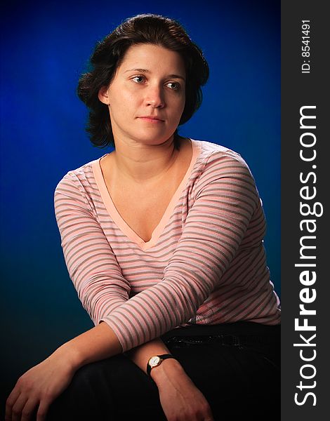 Portrait of female on a blue background in studio