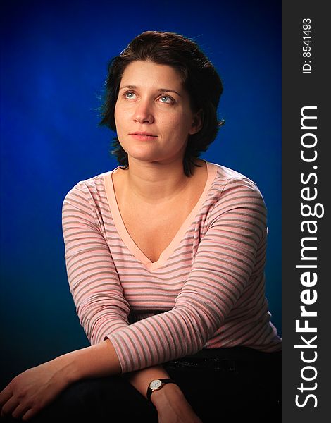 Portrait of female on a blue background in studio