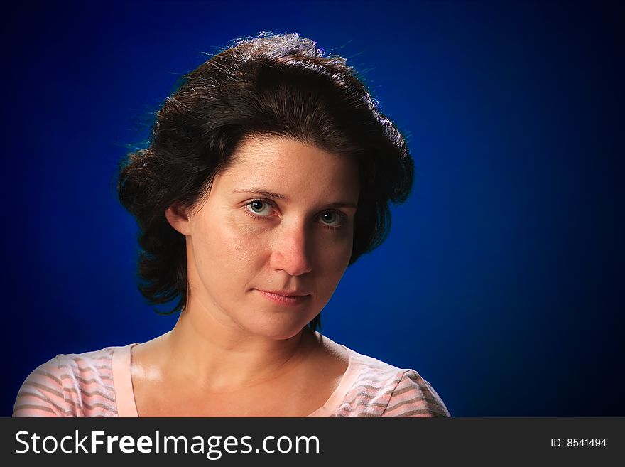 Portrait of female on a blue background in studio