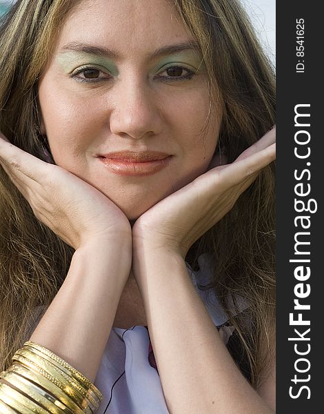 A half japanese, half german model, with gold bracelets, close-up.